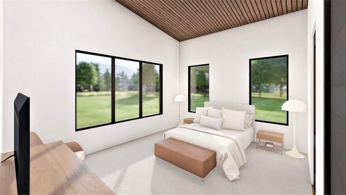 Primary bedroom with a carpeted floor, surrounding windows, and a platform bed complemented with a bench.