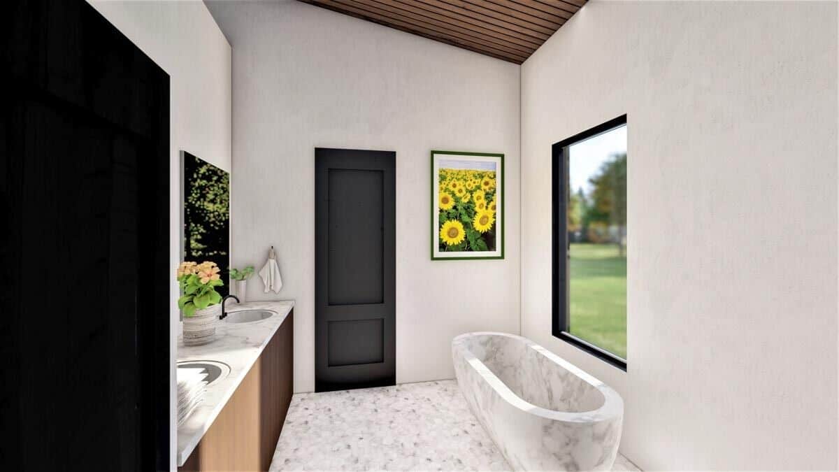 The primary bathroom offers a dual sink vanity and a marble tub brightened by a picture window.