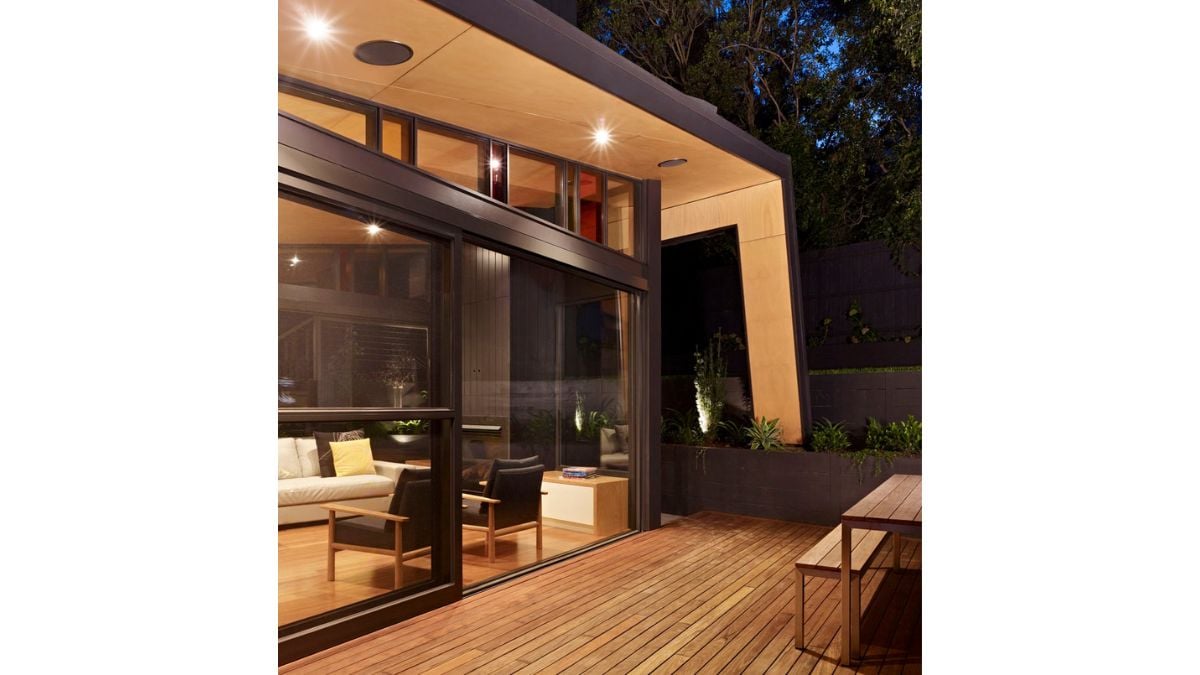 There is a glass wall that allows you to see both inside and outside as you pass through the patio.