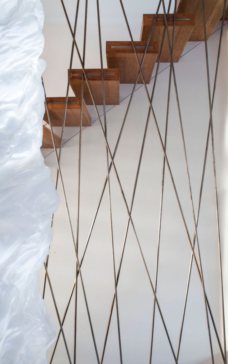 A unique design of floating stairs with wrought iron spindles.