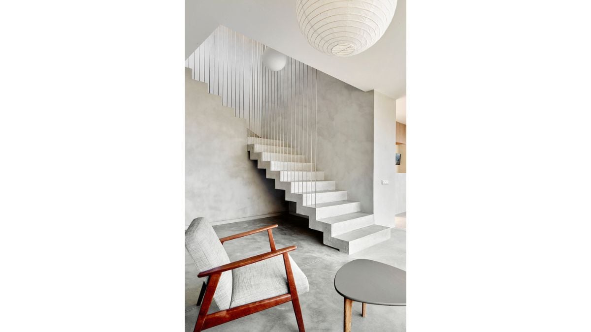 An artistic staircase serves as the vertical connection in the home's center region.