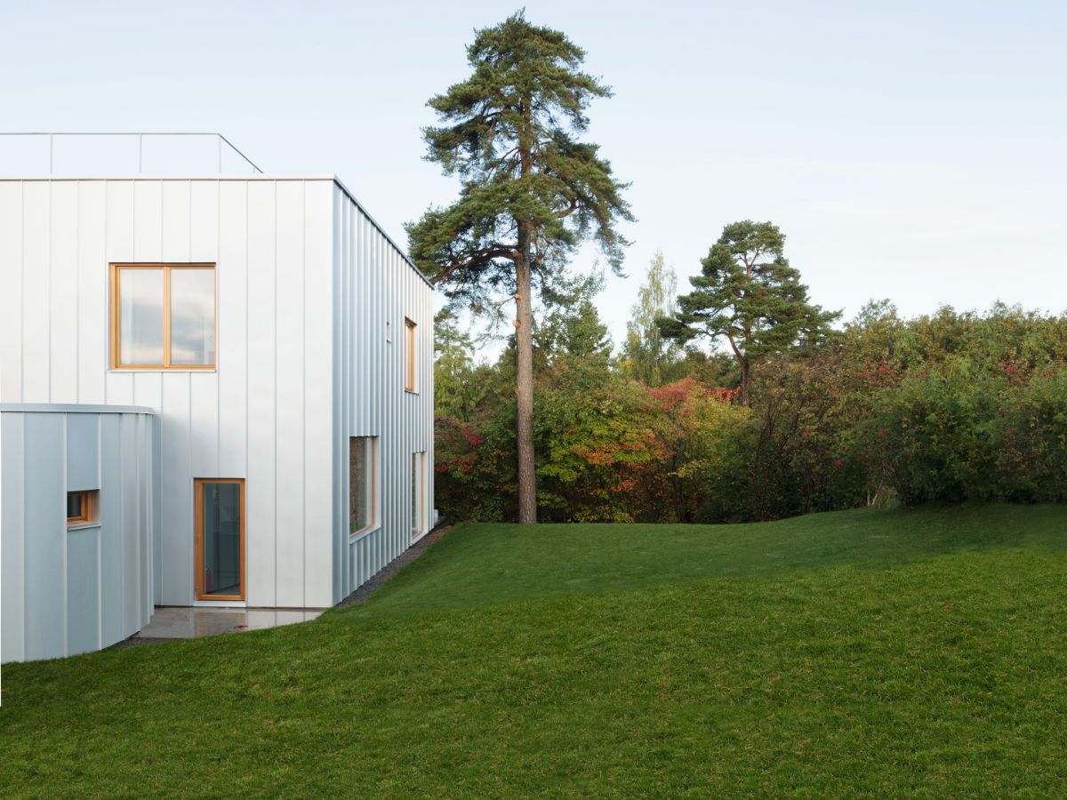 A house constructed within a larger flat with a submerged garage.