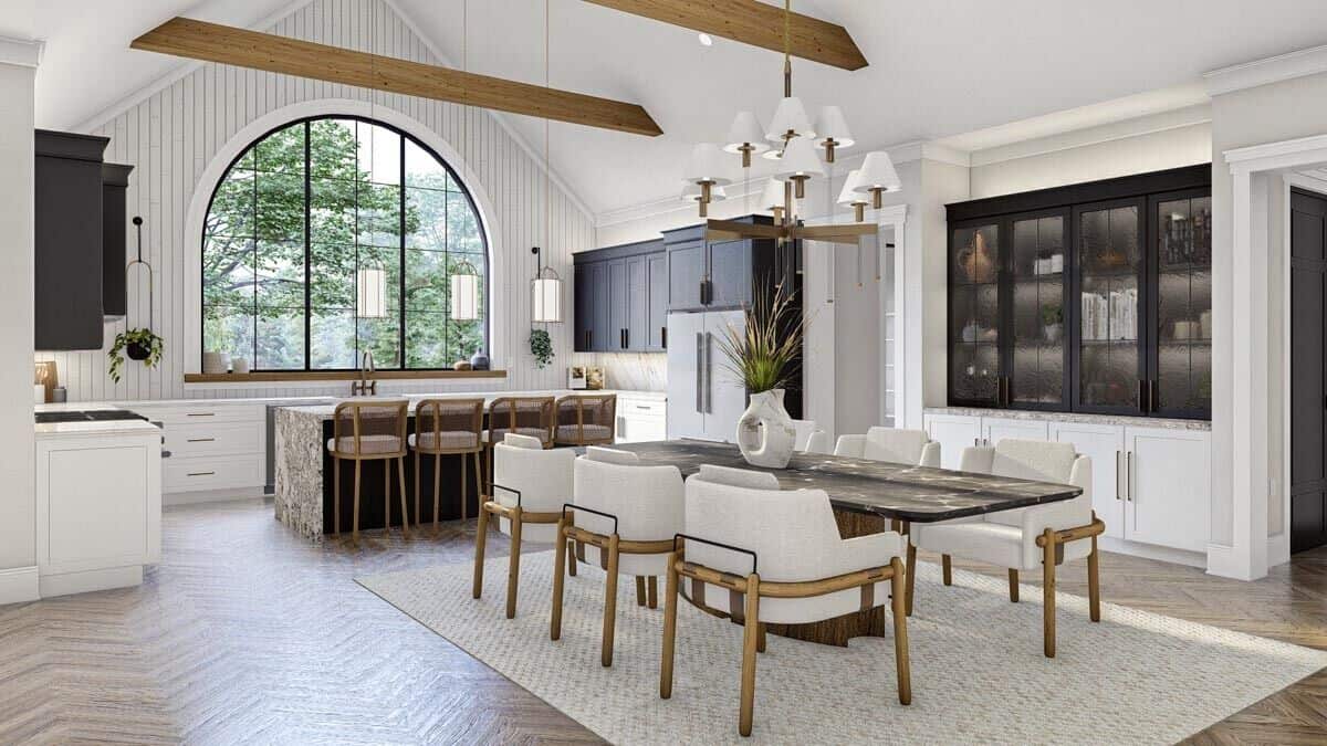The dining area includes a cathedral ceiling that spans through the kitchen.