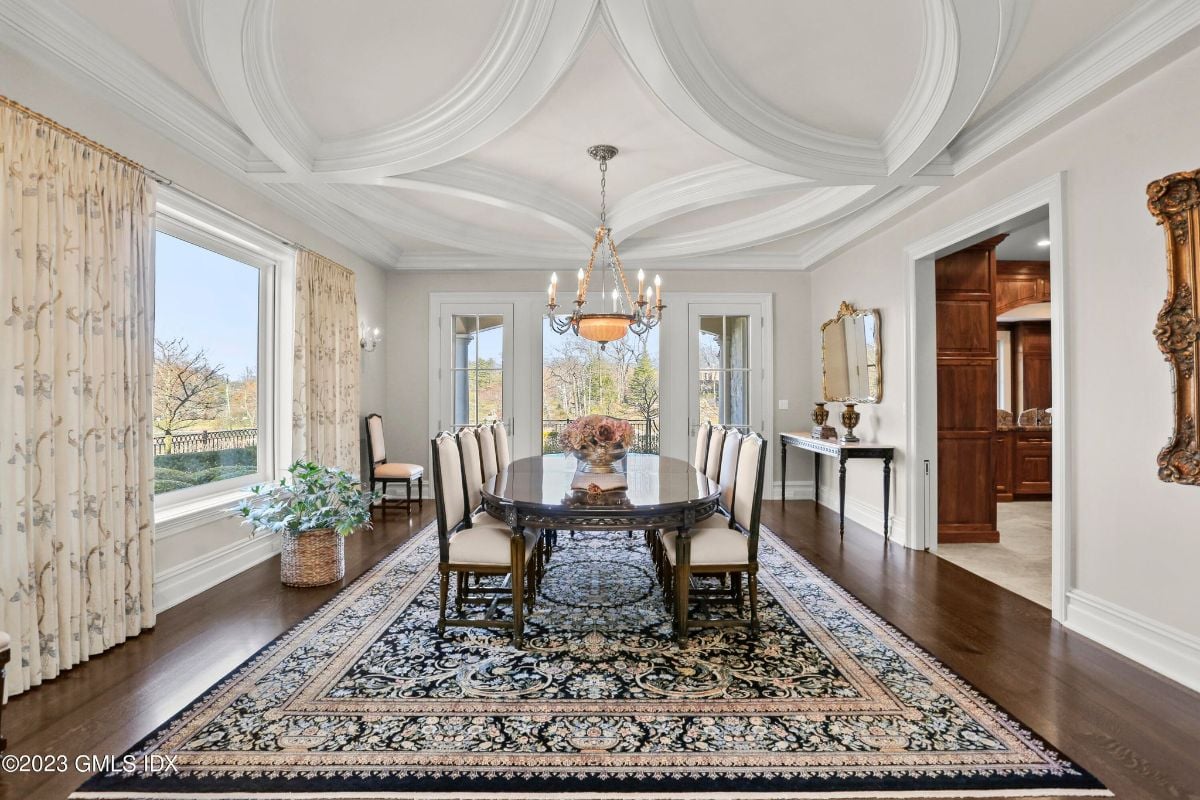 The dining room was a sight to behold, with a resplendent chandelier casting a warm glow over the luxurious table below, creating an atmosphere of sophistication and elegance.