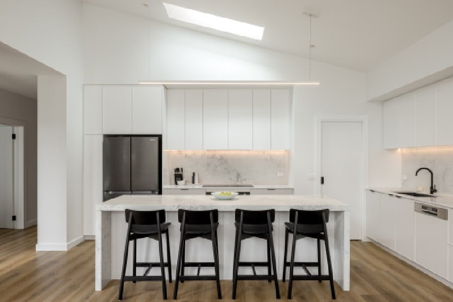 A contemporary kitchen with a raked ceiling.