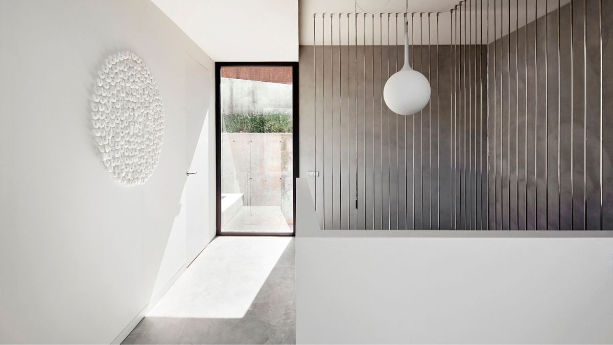 More white paint than grey paint is used on the upper portion of the home.