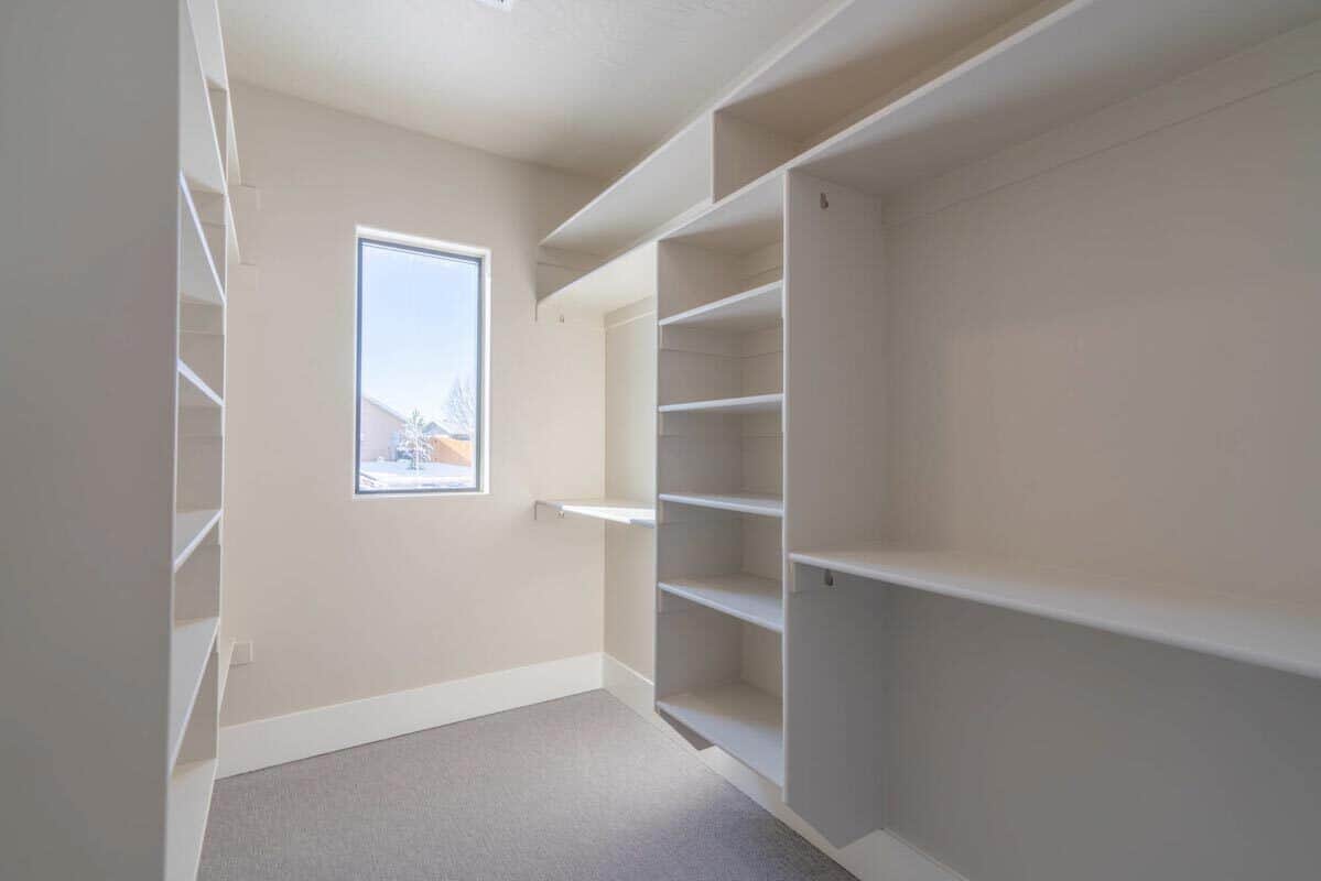 A picture window brightens the primary walk-in closet.