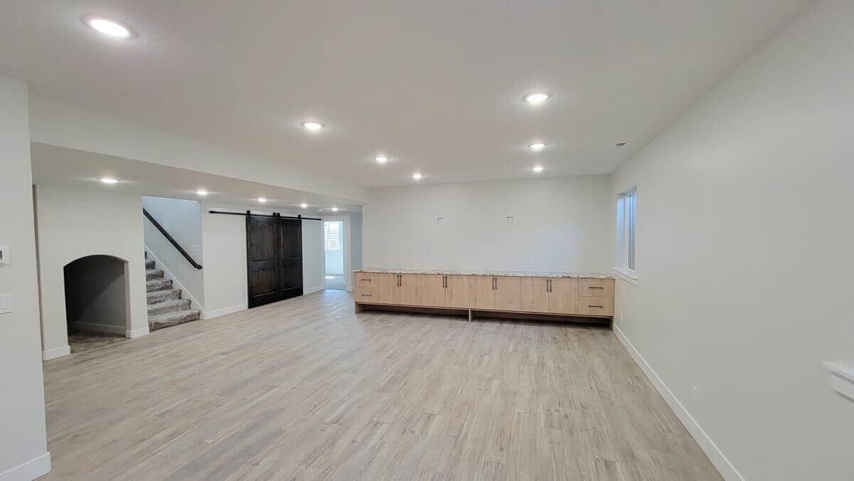 Spacious family room with hardwood flooring and built-in cabinet.