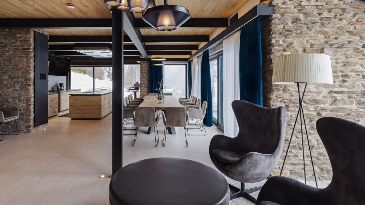 On the middle floor, a contemporary kitchen, as well as a sizable dining and living area, offer a congenial setting for shared living.