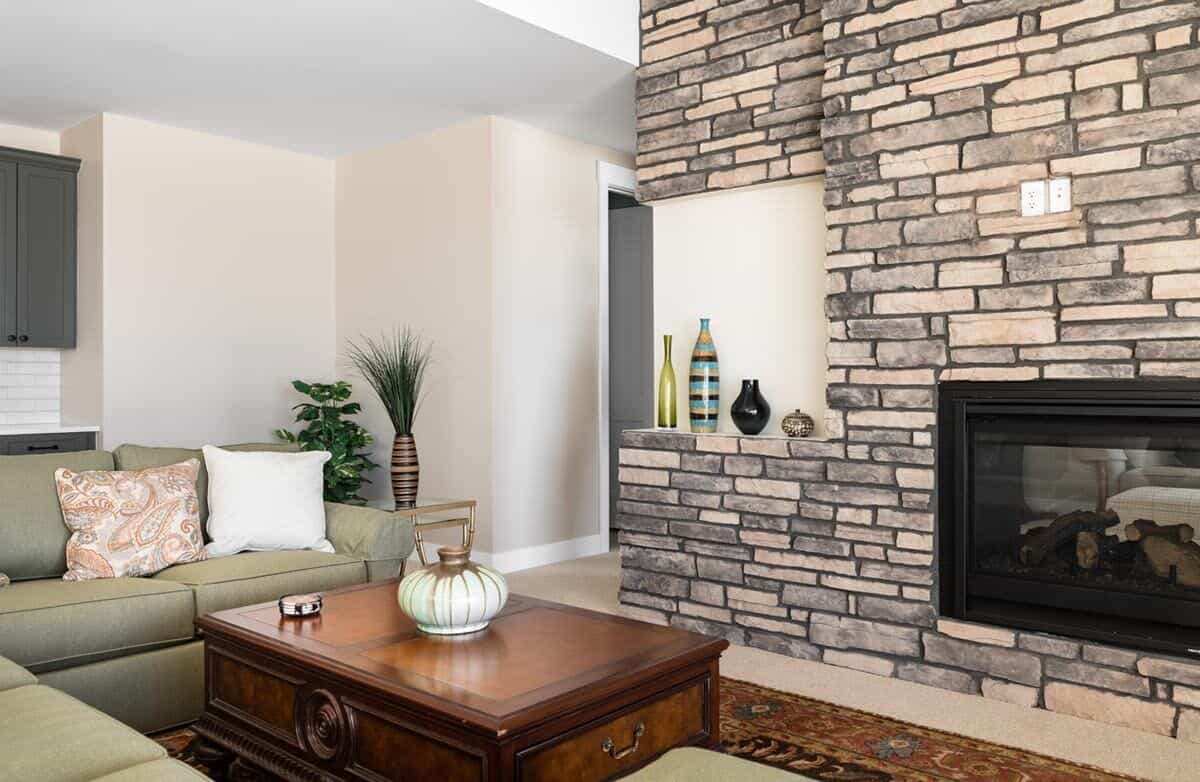 The great room includes a wooden coffee table and a wall niche filled with decorative vases.