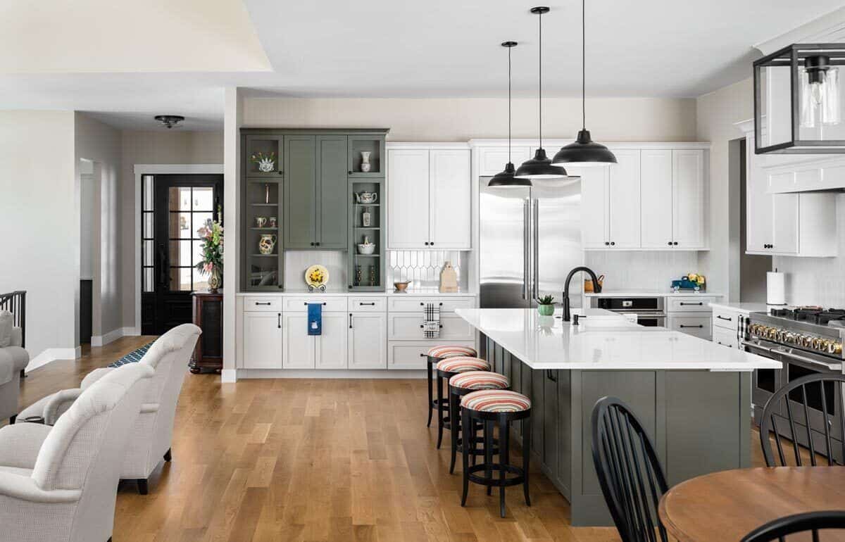 Round bar stools and dome pendants complement the kitchen island.