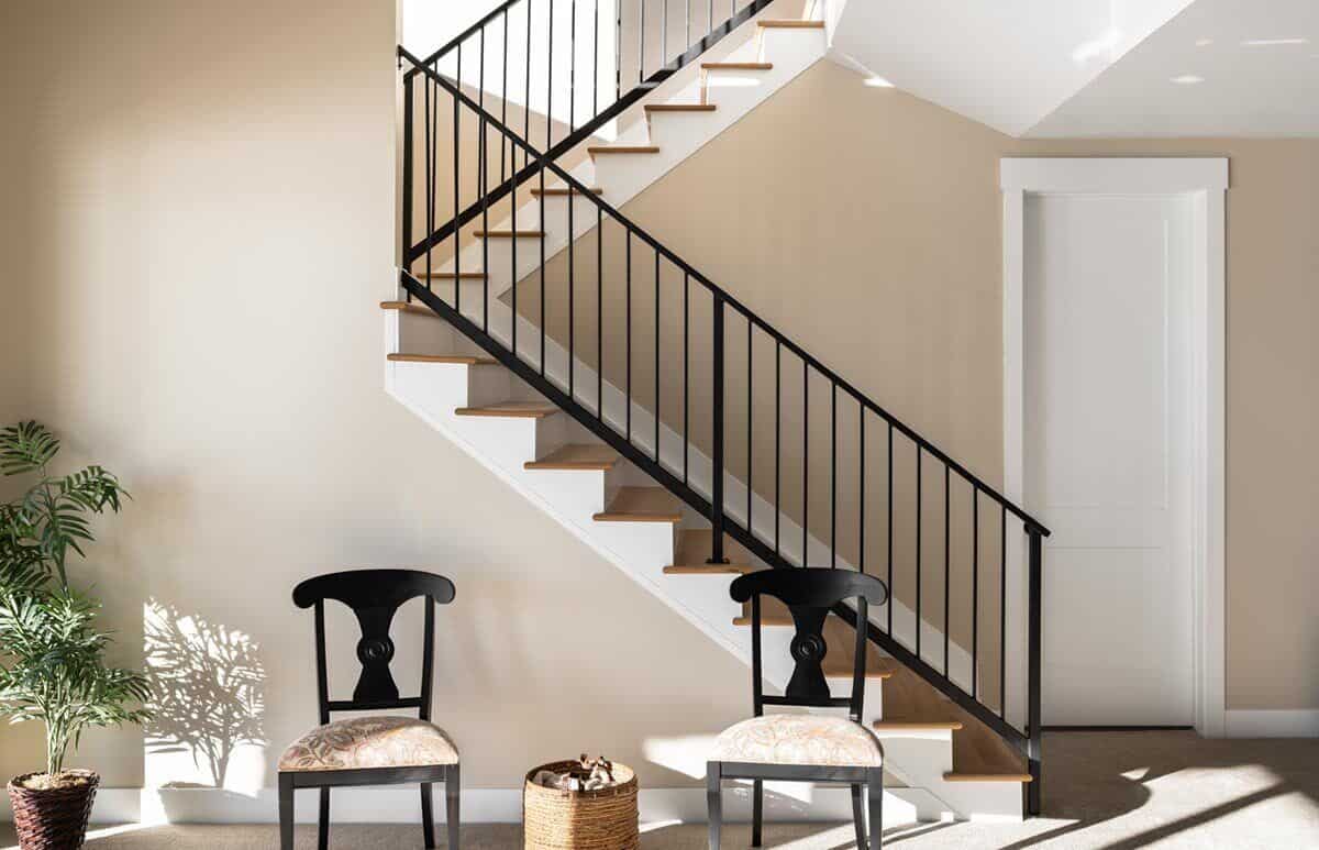 Cushioned chairs against the staircase provide a nice sitting area.