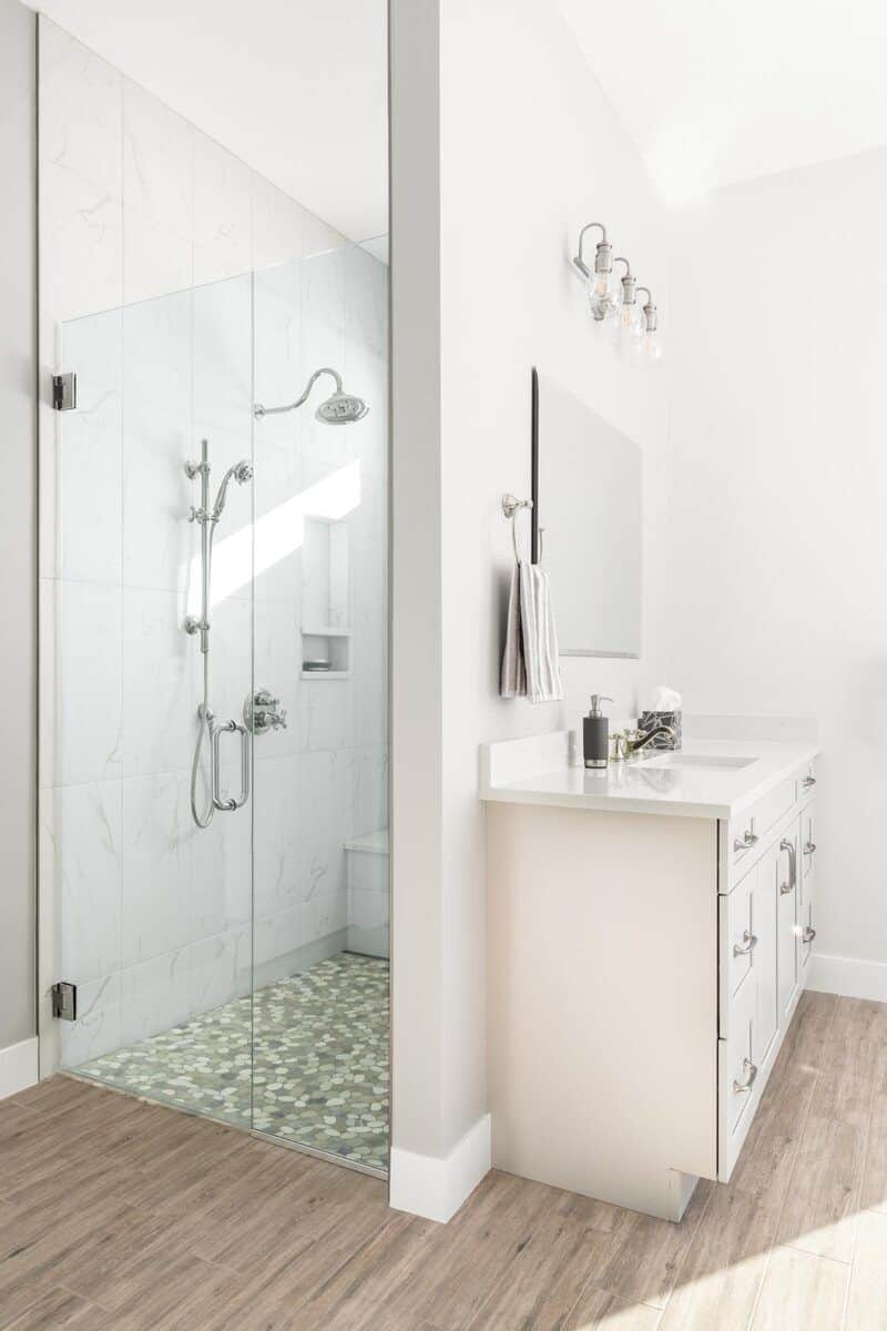 Primary bathroom with a sink vanity and a walk-in shower.
