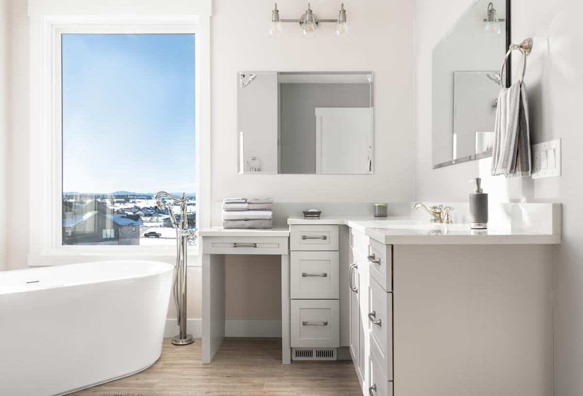 The primary bathroom includes a freestanding tub brightened by a picture window.