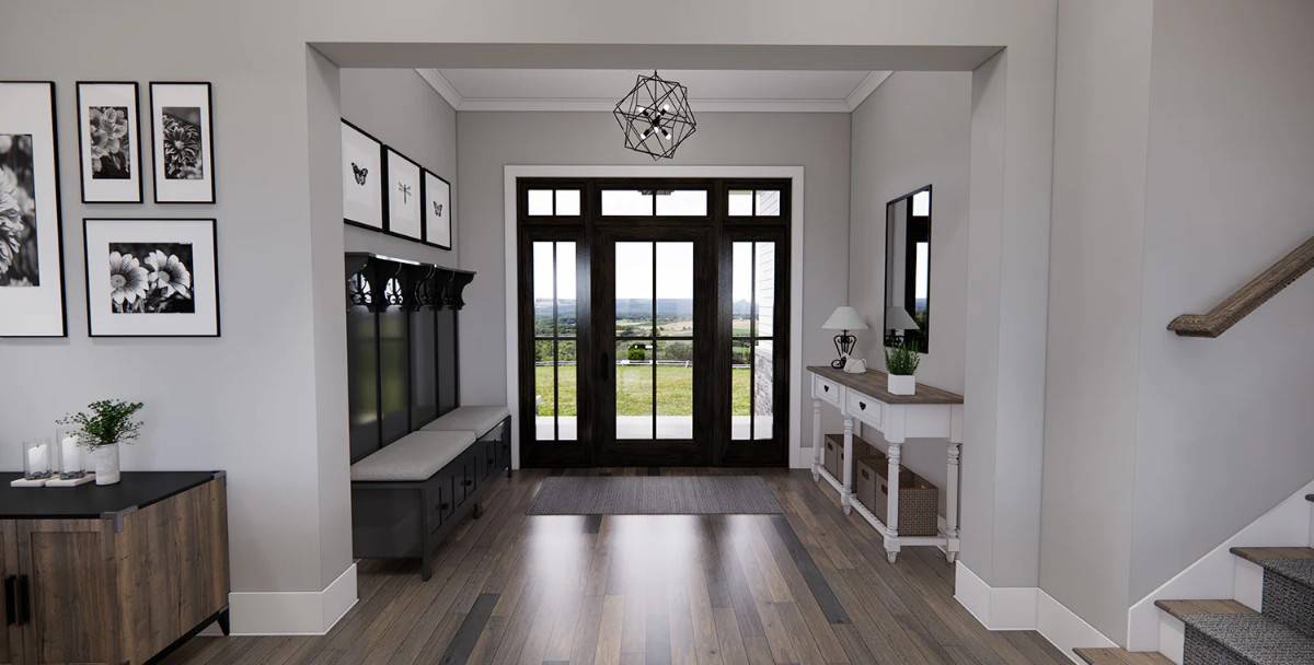 Foyer with a glazed entry door, a wooden console table, and a cushioned bench.
