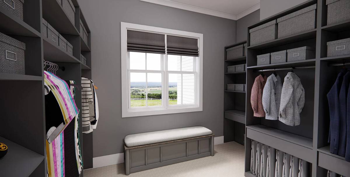 A large white framed window brings natural light to the primary walk-in closet.
