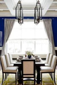 Bold bright and deep blue tones adorn the walls in this beautifully designed contemporary dining room.