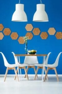 Rich blue walls and stark white gloss floors contrast together to create this minimal Scandinavian style dining room.