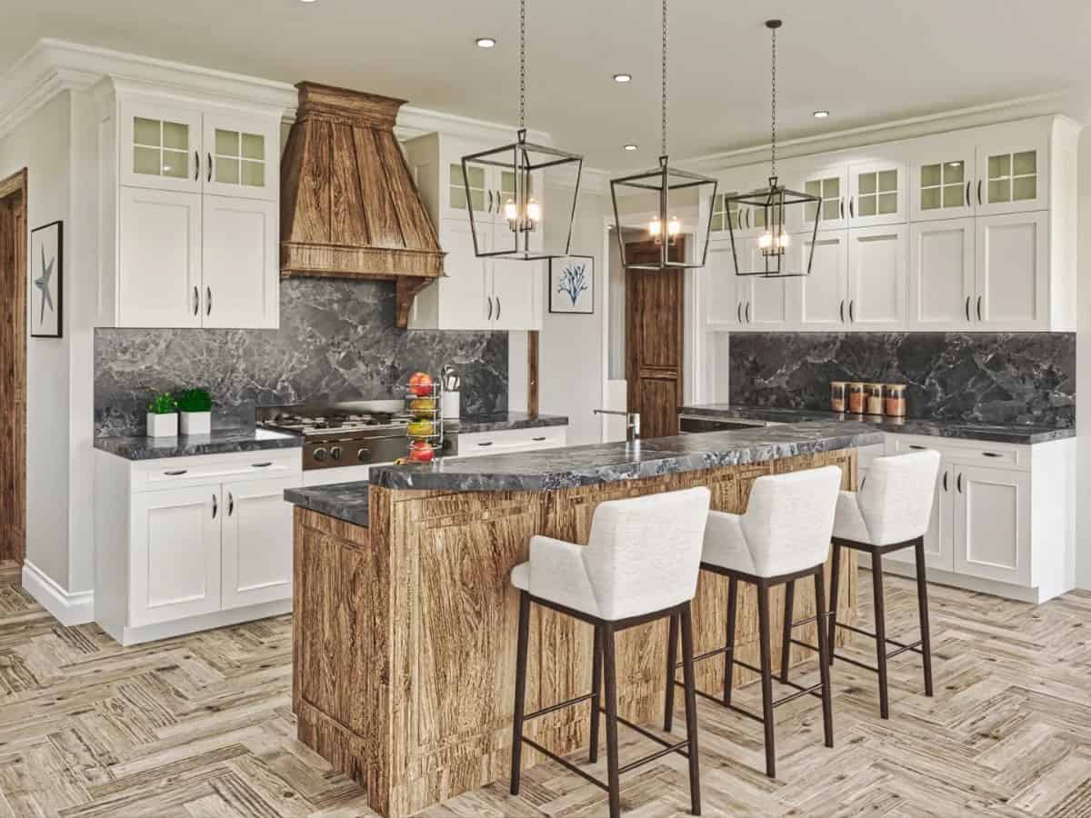 The kitchen has white cabinetry, contrasting marble countertops, and a center island with a raised eating bar.