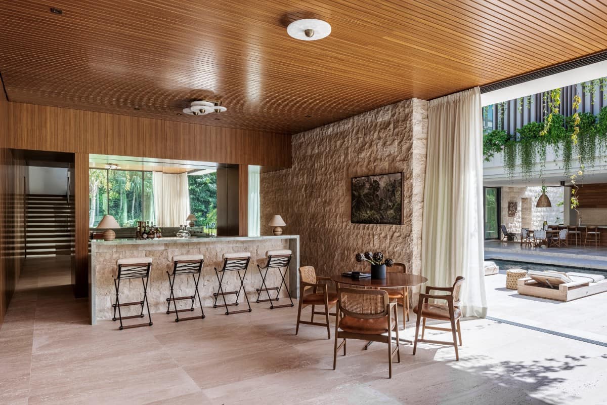 The design pays homage to the clients' Brazilian heritage, serving as a showroom for the vintage furniture and artwork that they have collected throughout the years.