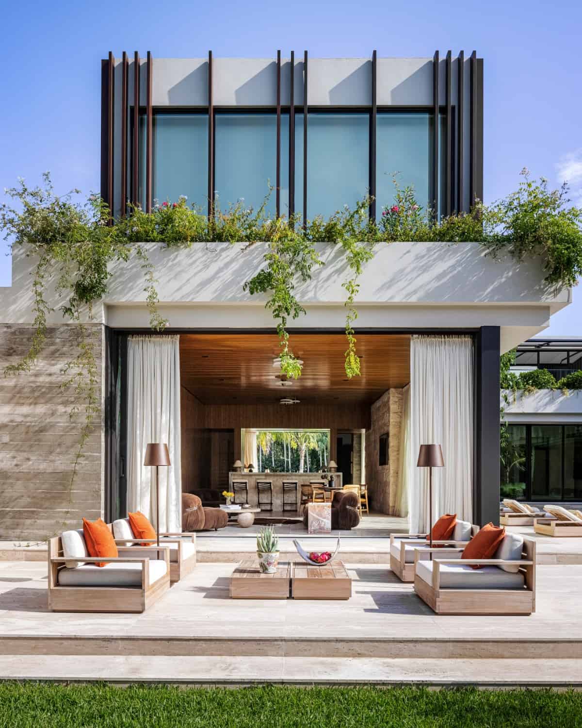 The team skillfully blended striking materials, a thoughtful composition and the tropical location with the owners' Brazilian-influenced art and furniture to evoke the essence of a South American home.