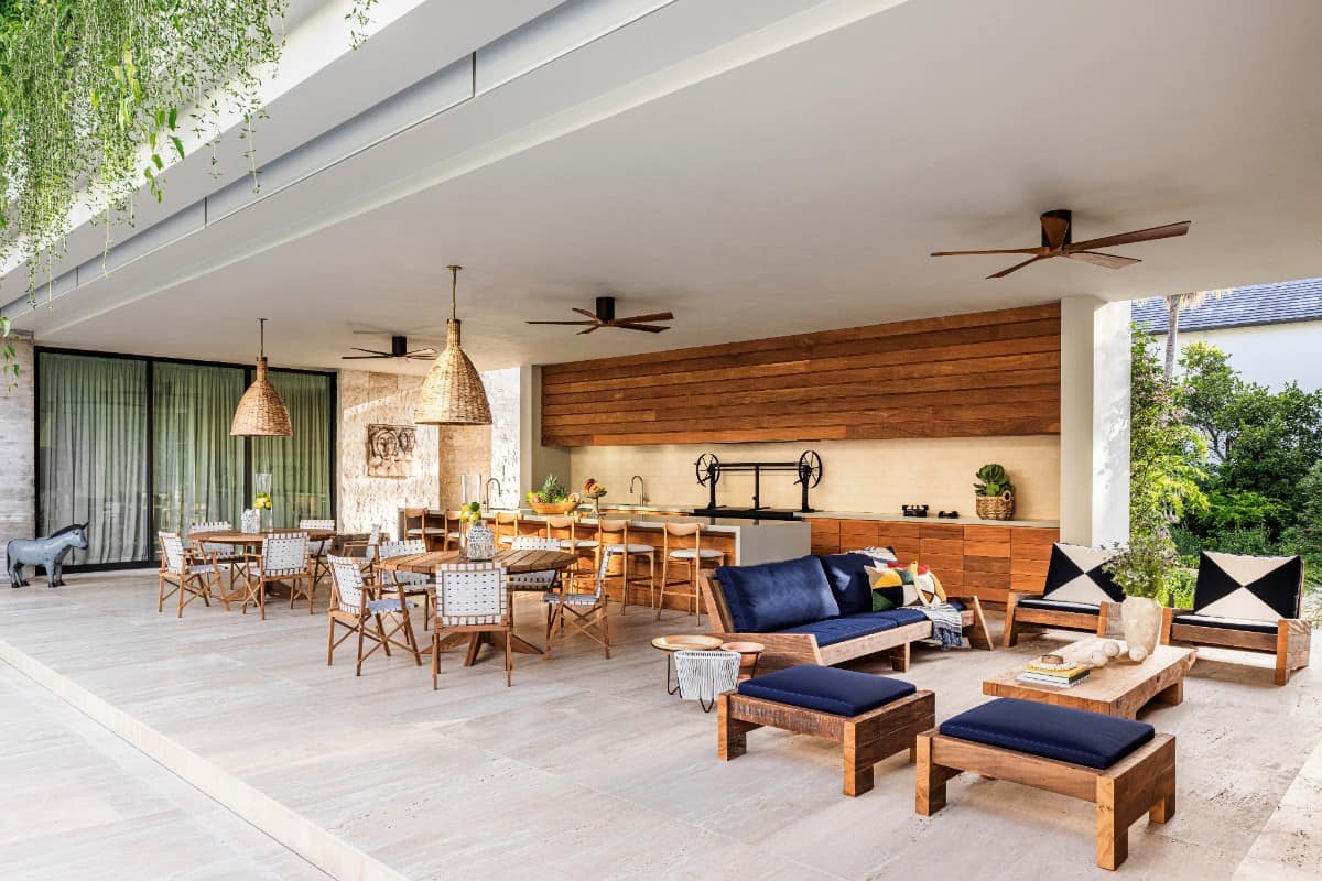 Unfilled travertine flooring crosses from the patio to the interior, creating an overall sense of warmth.