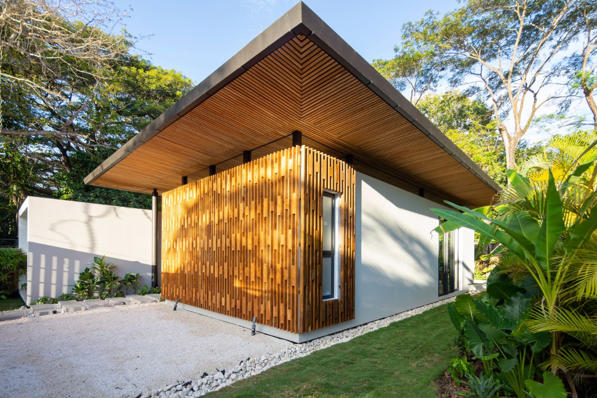 The house is built with broad rooflines that provide shelter and the option of living outside in nature.