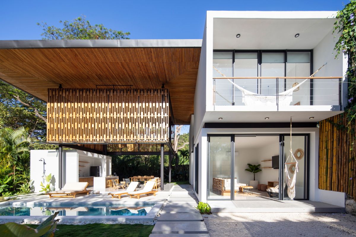 A vertical roof-like umbrella creates an atrium where people may enjoy natural light and the outdoors while staying dry.