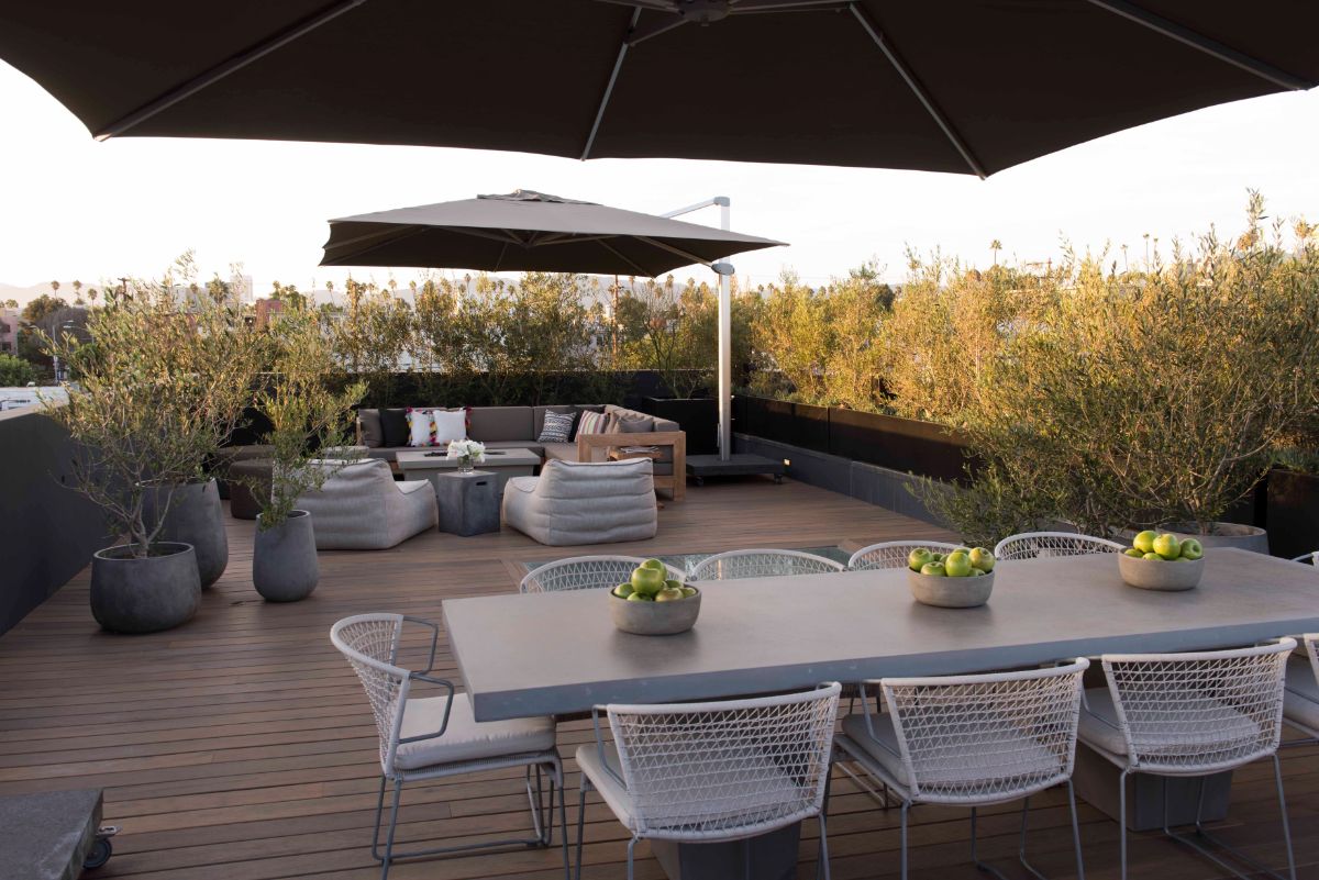 The roof garden's large dining room and an outdoor lounger with a fire pit.