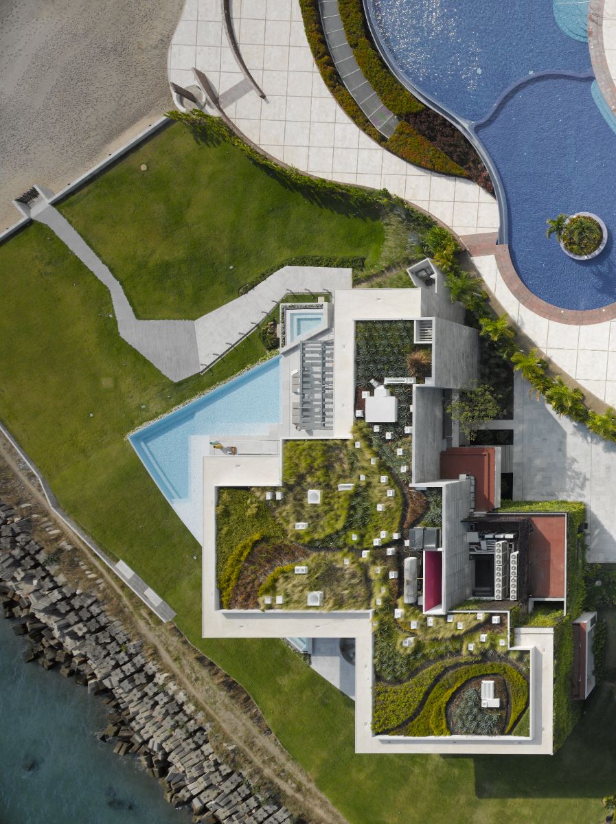 Aerial view of the house with rooftop gardens provides a beautiful view for the users of the next building.