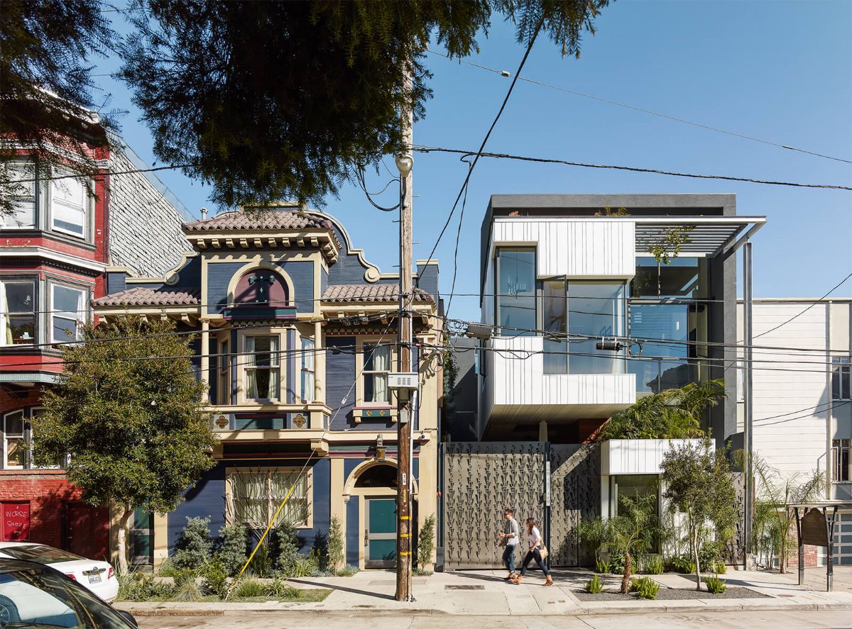 The street facade of the new three-unit building tucked alongside the mission district offers a warm and sophisticated presence while respecting the older neighborhood fabric.