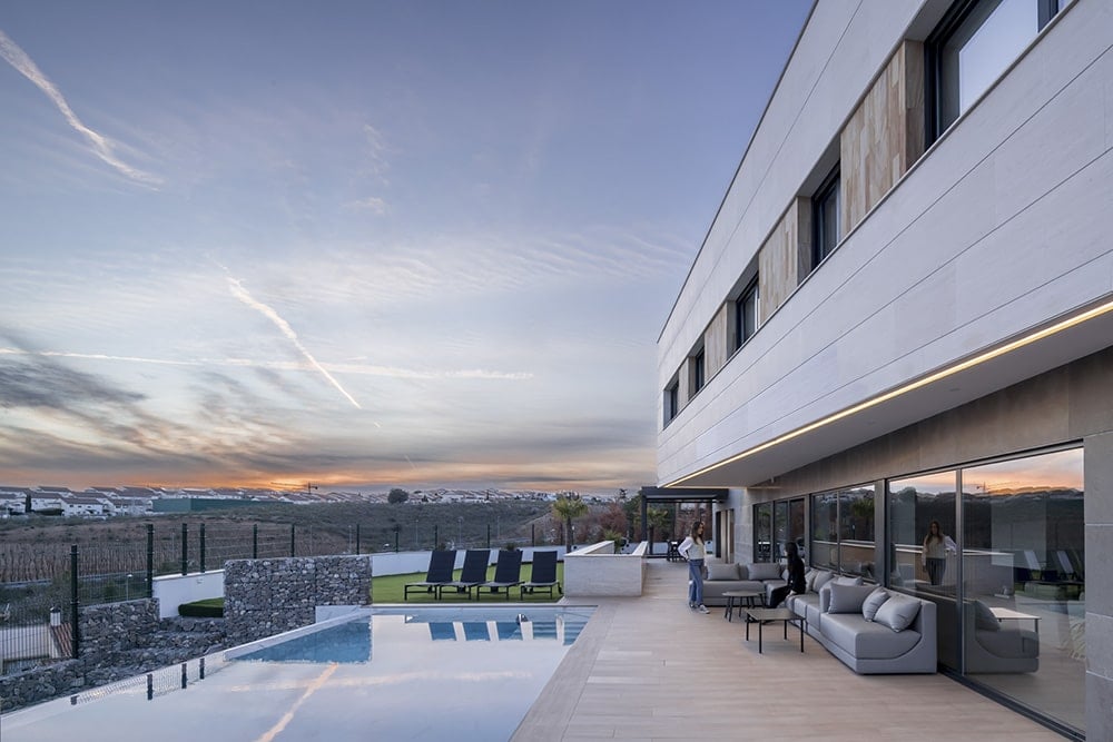 Spacious outdoor living with multiple seating areas and a swimming pool.