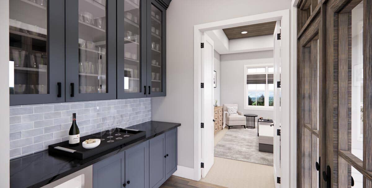 A bar equipped with a beverage fridge and glass-front cabinets leads to the primary bedroom.