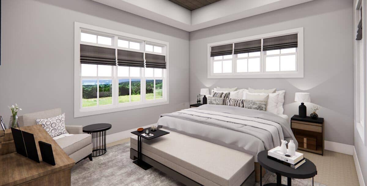 The primary bedroom has a tray ceiling and carpeted floor topped with a distressed area rug.