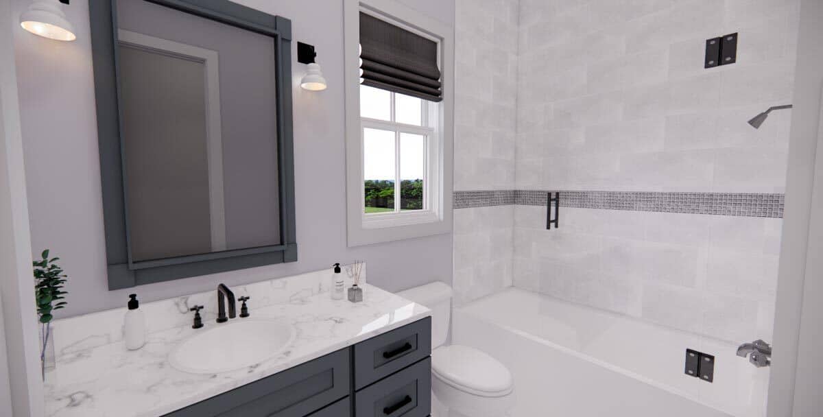 This bathroom offers a marble-top vanity and a tub and shower combo enclosed in frameless glass panels.