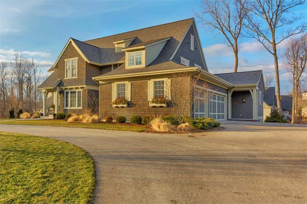 Front-right exterior view with a side-loading garage and a small covered porch.