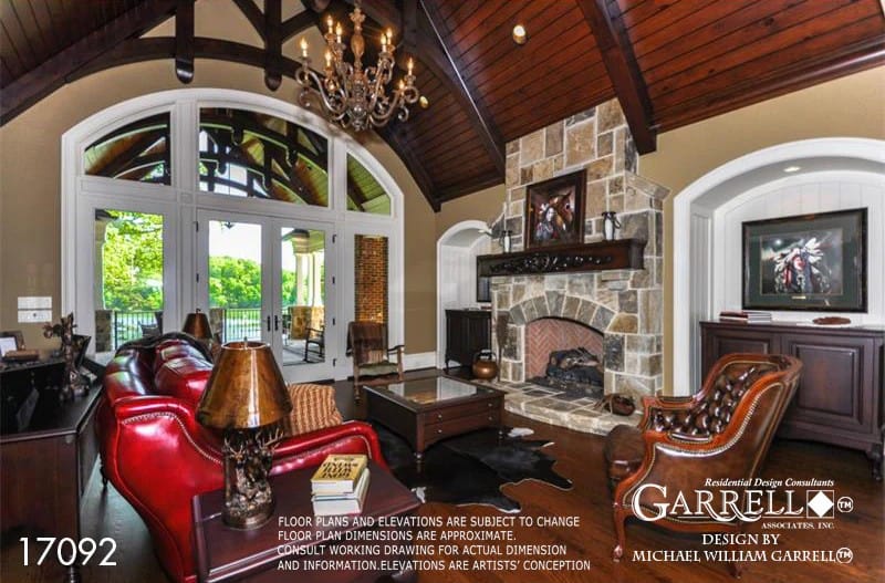 The lodge room has leather seats, a stone fireplace, and a cathedral ceiling framed with exposed trusses.