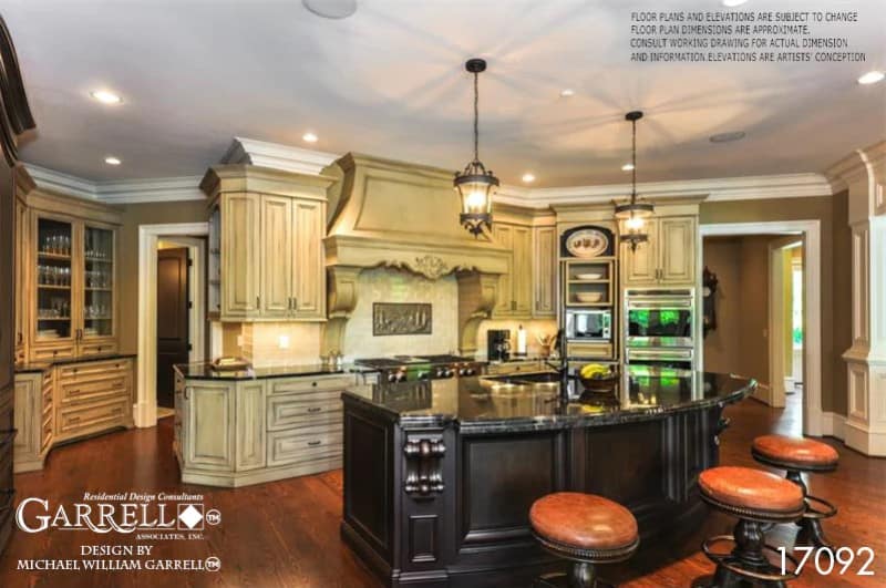 The kitchen offers tons of storage and workspace including a large island with a curved eating bar.