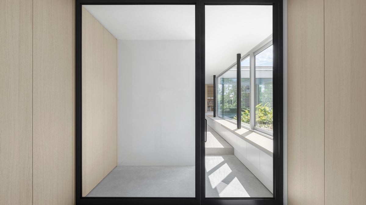 A sliding door with a hazy design gives the home privacy and openness.