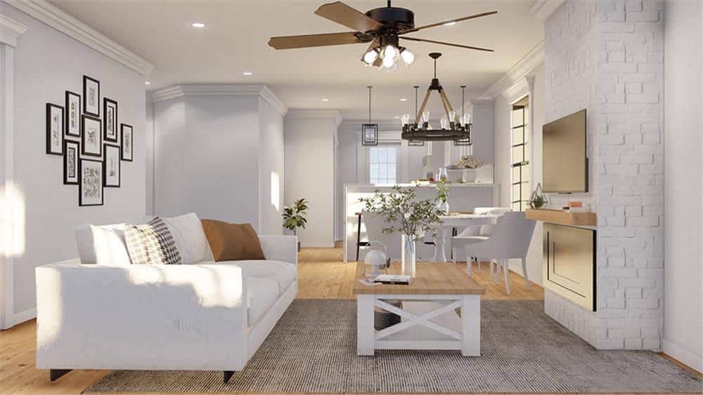 Great room with a large sofa, a wooden coffee table, and a brick fireplace topped with a TV.