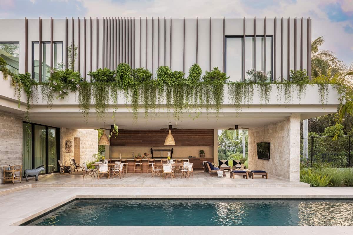 The home's unique footprint forms a protected courtyard for the pool, which extends into the rear yard.