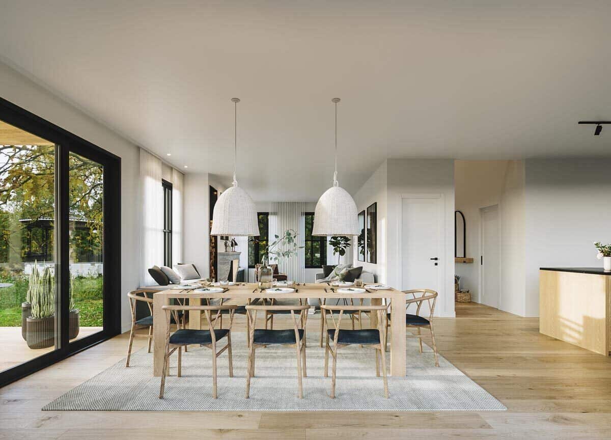 The dining area features an 8-seater wooden dining set topped with a couple of wicker pendants.