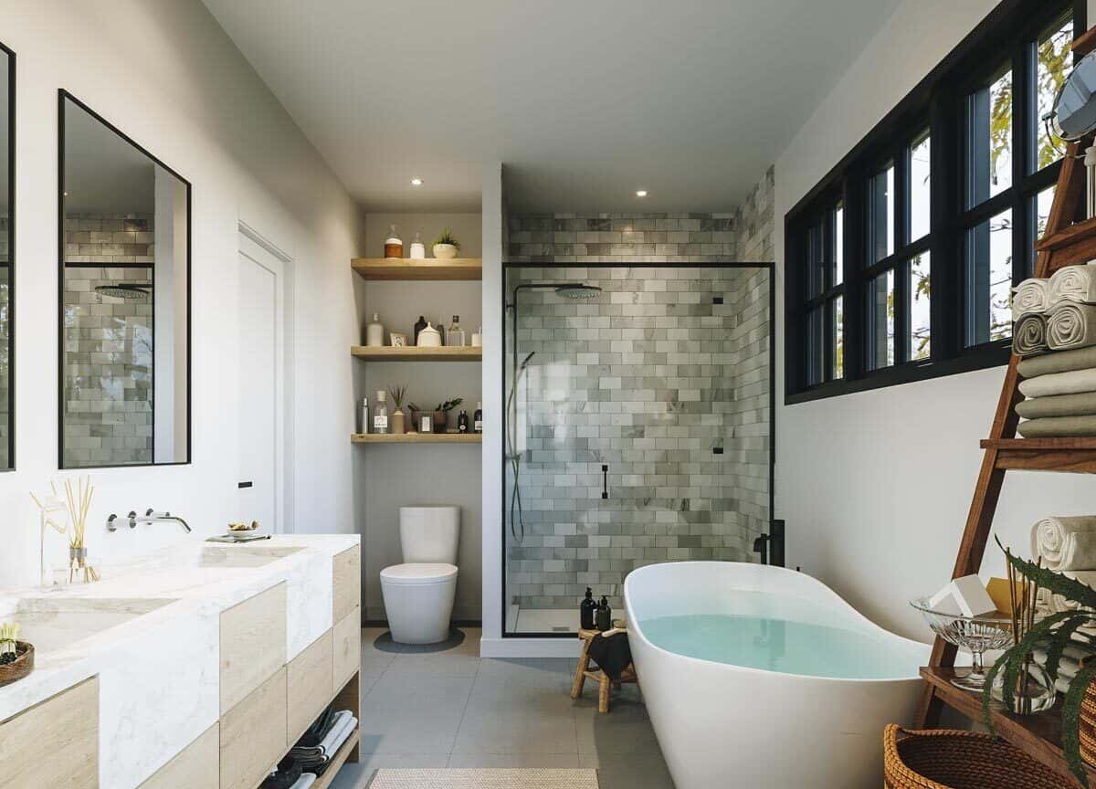 The primary bathroom offers a large vanity, a toilet, a freestanding tub, and a walk-in shower.
