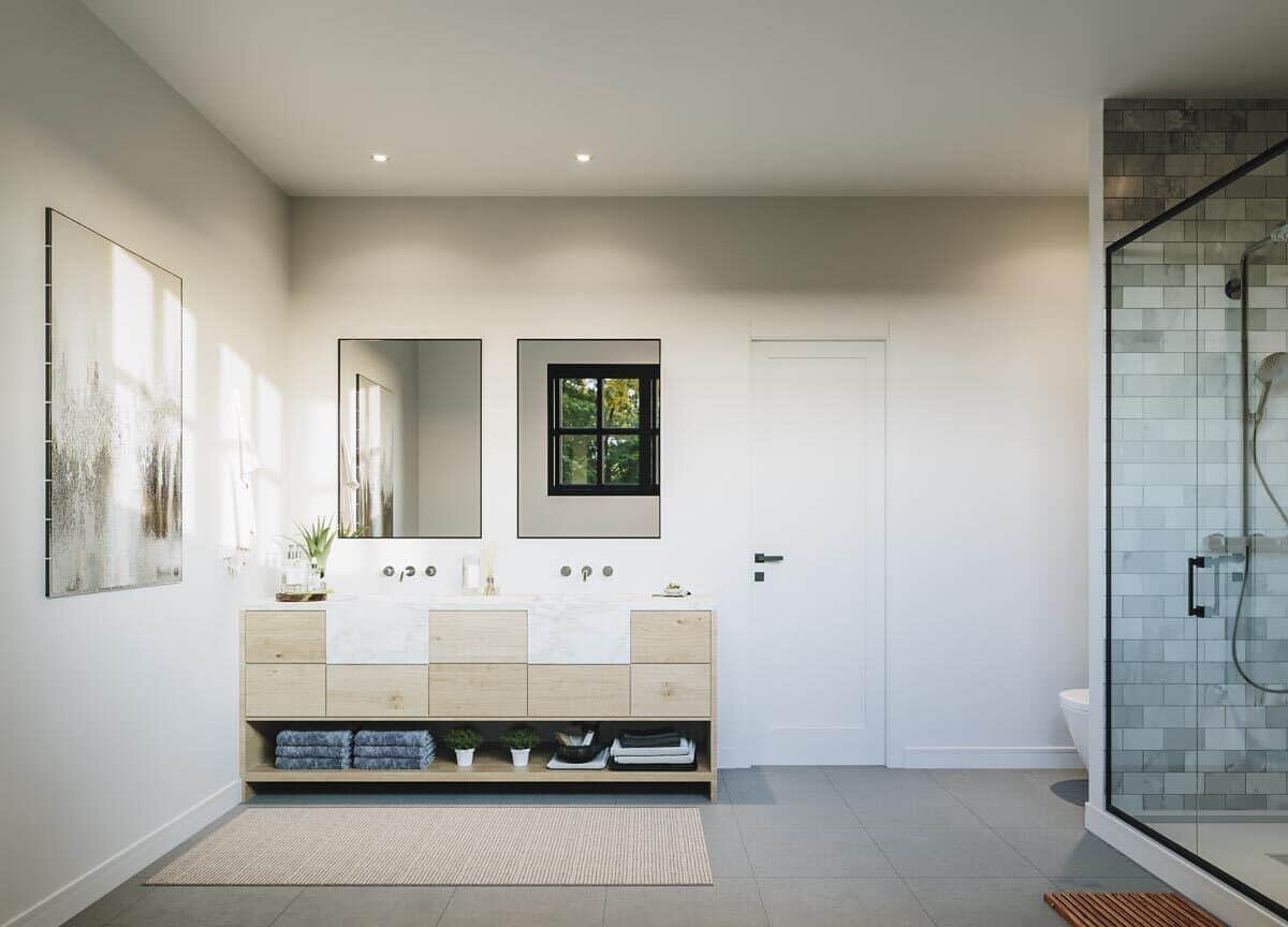 The primary vanity is equipped with a marble countertop, two sinks, and framed mirrors.