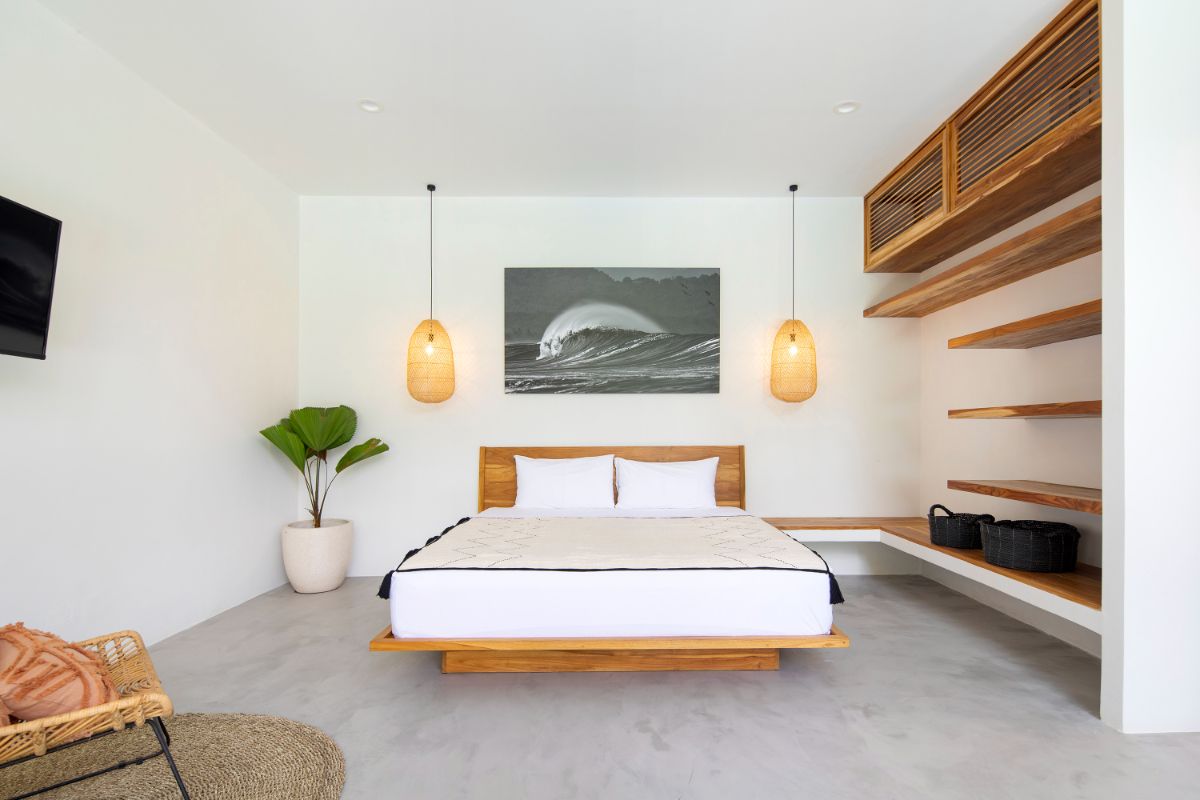 The bedroom is more private, with solid elements separating it from the open living spaces.