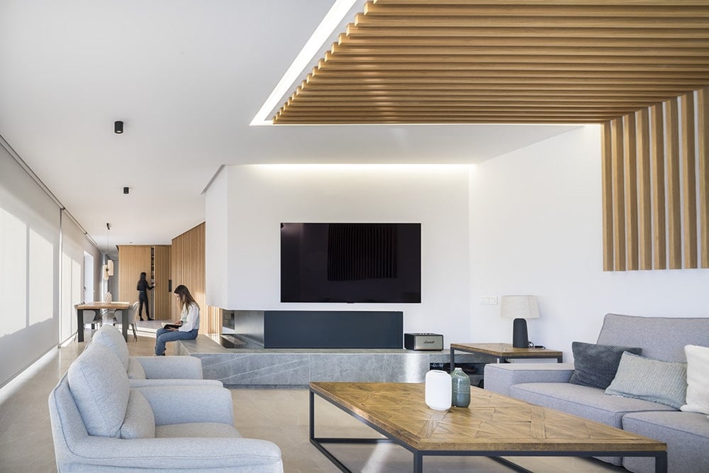 A large TV and fireplace enhance the entertaining in the living room.