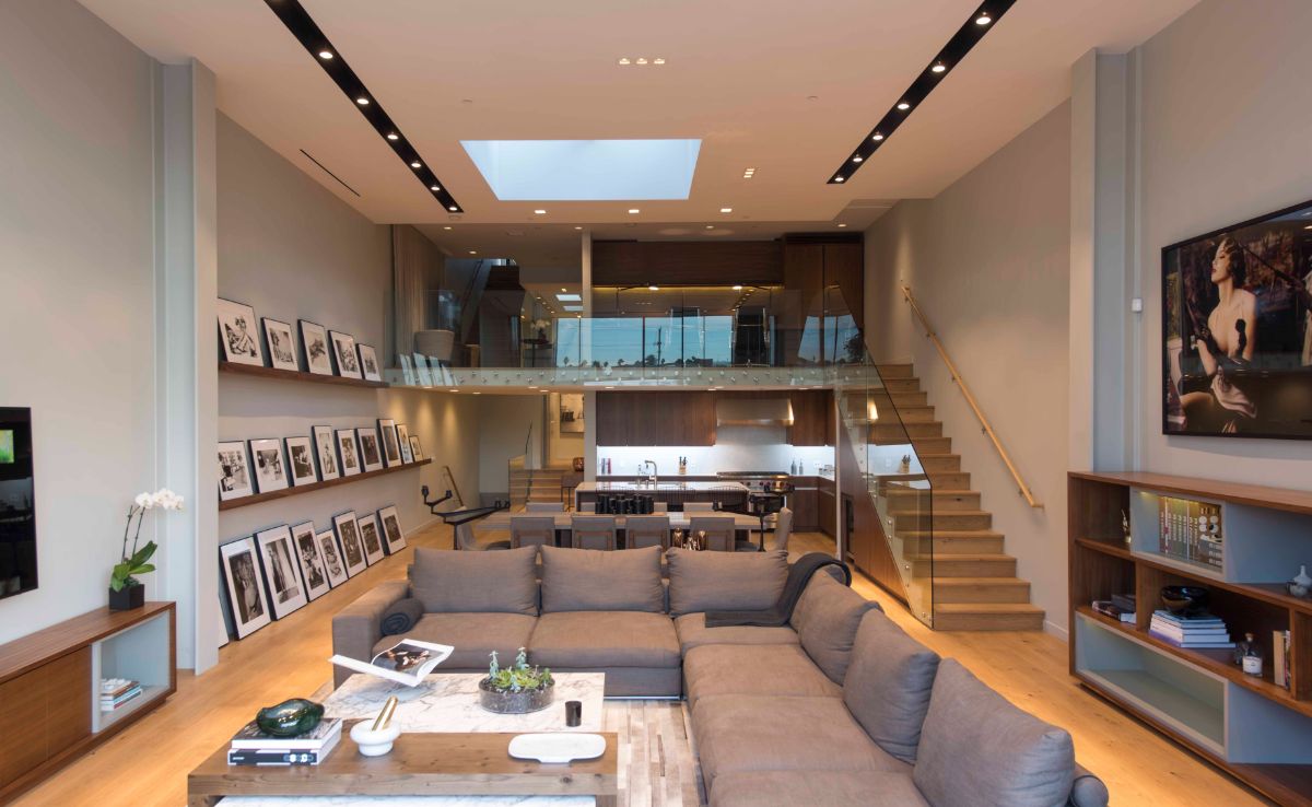 An open living, dining, and kitchen layout in which the owner showed his collection of contemporary photography.