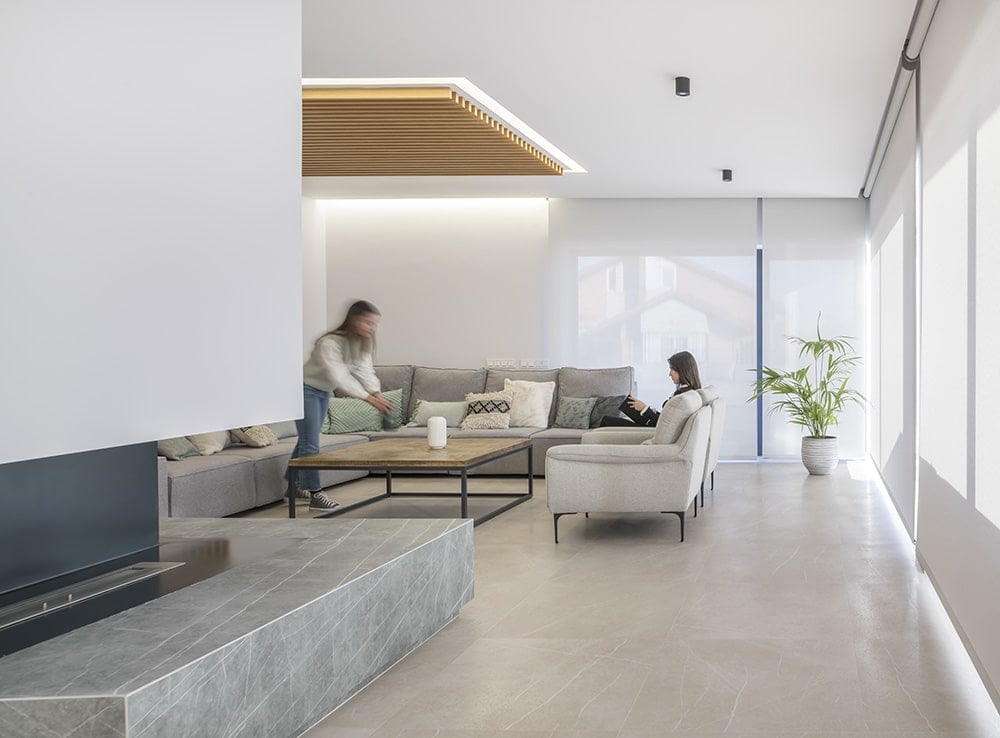 The living room includes tiled flooring and floor-ceiling windows that bring an abundance of natural light in.