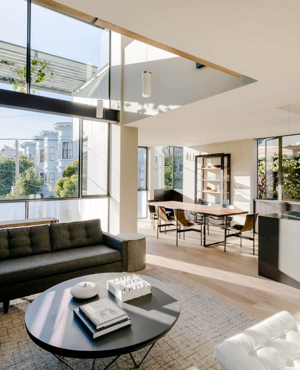 The "street house" unit also offers an open concept living, dining, and kitchen. The materials used emphasize contemporary design. The large windows flood the room with natural light.