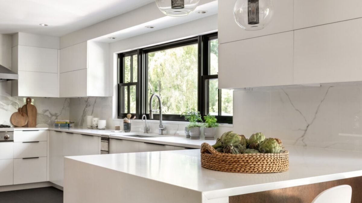 The kitchen's all-white design elements go well with the natural light that comes in.